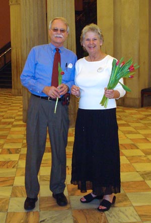 Photo of two people holding red tulips at SC State House