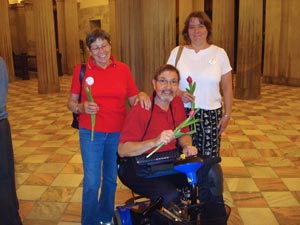 Photo of three family members holding red tulips at SC State House