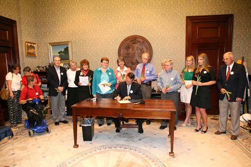 Group photo of Parkinson community watching Governor Sanford signing proclamation
