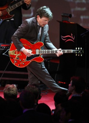 Michael J. Fox playing a guitar